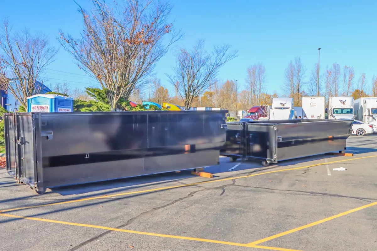 Professional dumpster rental service with roll-off container on residential driveway in Douglass Hills